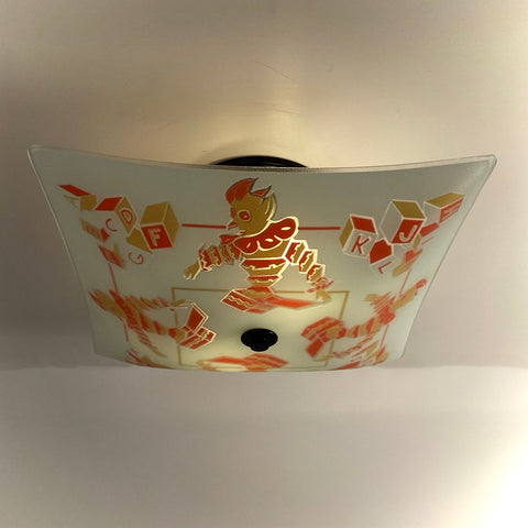 Square frosted glass ceiling light shade featuring vintage nursery clowns and alphabet blocks, illuminated from within.
