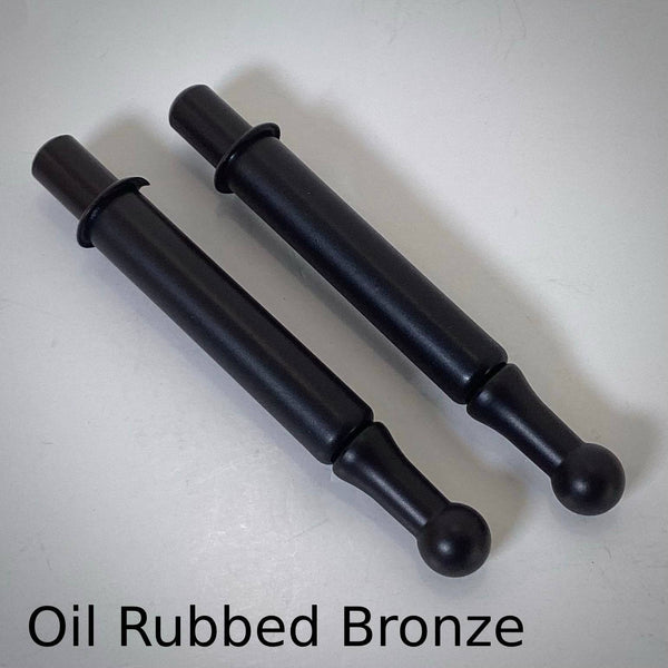 Pair of oil-rubbed bronze window sash spring bolts featuring a matte black-bronze finish.