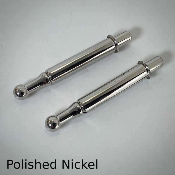 Pair of polished nickel window sash spring bolts with a mirror-like silver reflective finish.