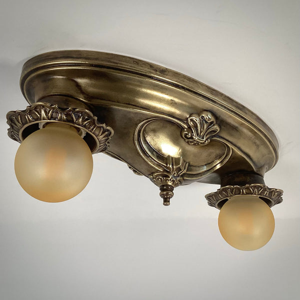 Victorian era style brass ceiling fixture turned off, featuring decorative floral filigree sockets.