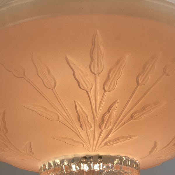 Close-up view of the intricate embossed floral sprig pattern on a pink frosted depression glass shade.