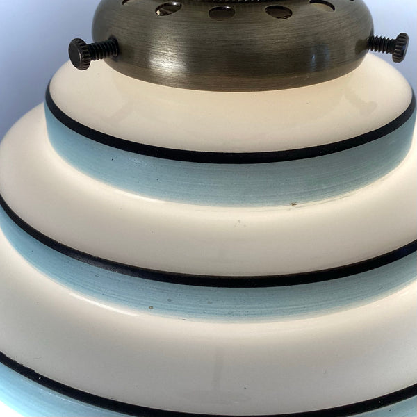 Close-up of stepped Art Deco glass shade with sky-blue and black accent rings