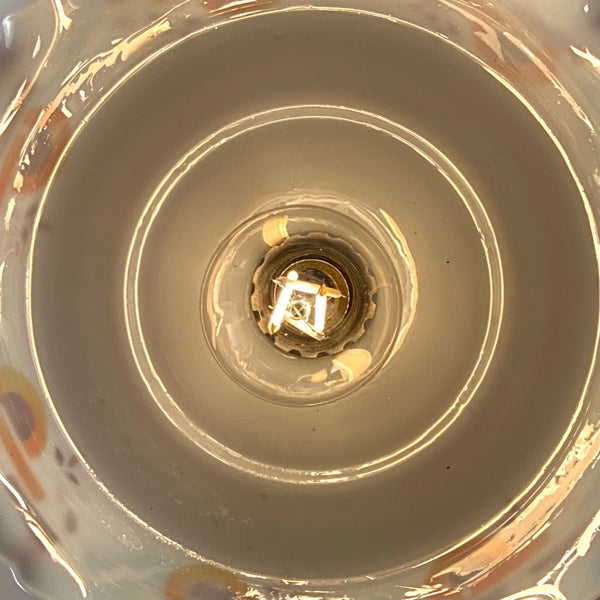 Interior view of a vintage opal glass pendant shade showing the electrical socket and bulb placement.