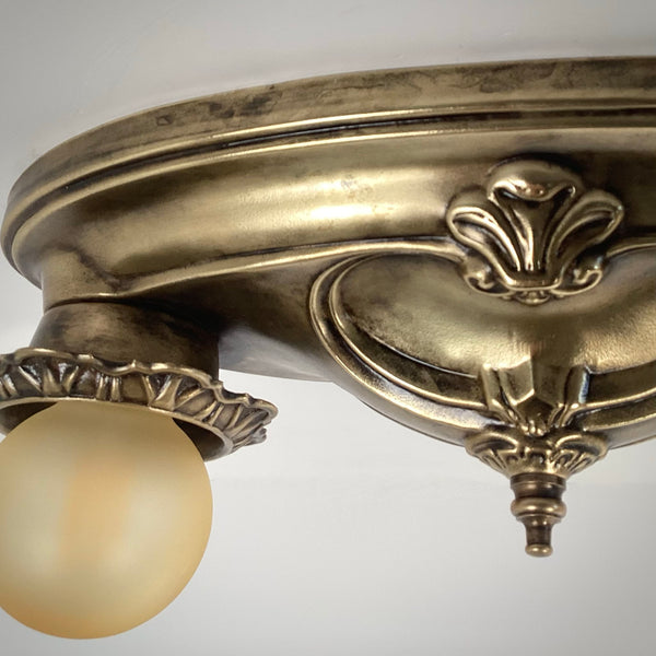 Detailed view of the decorative brass base plate casting and center teardrop finial.