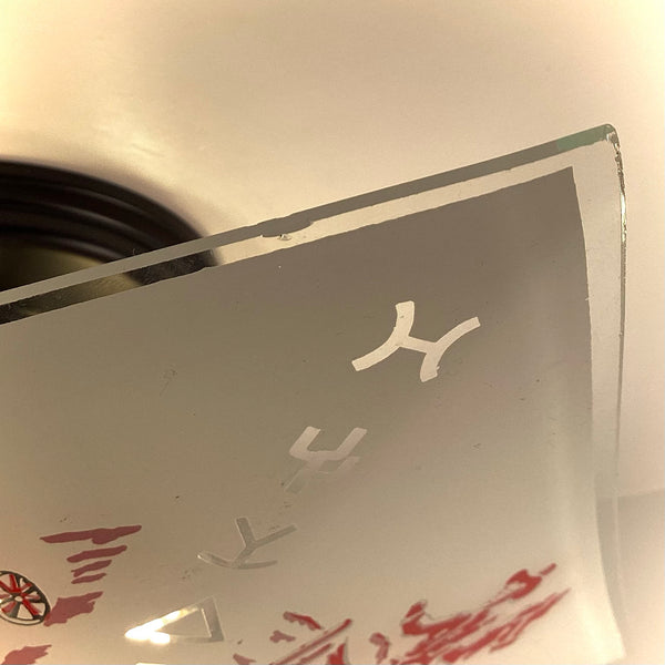 Close-up detailing the clear glass edge and corner condition of a vintage Western-themed light shade.