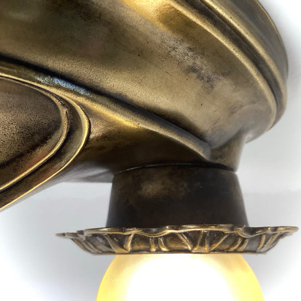 Close-up showing the junction between the socket cup collar and ceiling fixture plate.