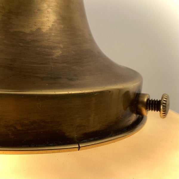 Extreme close-up of a brass shade fitter gallery cup with set thumb screw.