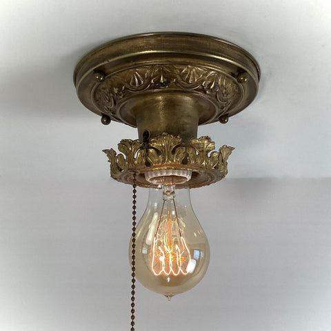 Antique Brass Flush Mount Ceiling Light with Pull Chain. The fixture has been rewired, cleaned, and detailed and retains much of its aging and wear. It also includes the hardware for easy installation. Available at www.vintporium.com