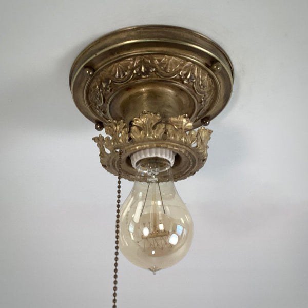 Antique Brass Flush Mount Ceiling Light with Pull Chain. The fixture has been rewired, cleaned, and detailed and retains much of its aging and wear. It also includes the hardware for easy installation. Available at www.vintporium.com