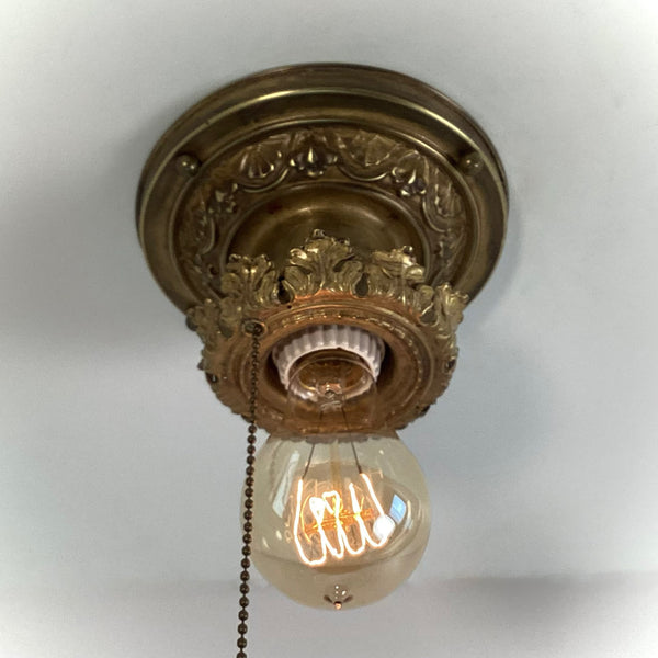 Antique Brass Flush Mount Ceiling Light with Pull Chain. The fixture has been rewired, cleaned, and detailed and retains much of its aging and wear. It also includes the hardware for easy installation. Available at www.vintporium.com