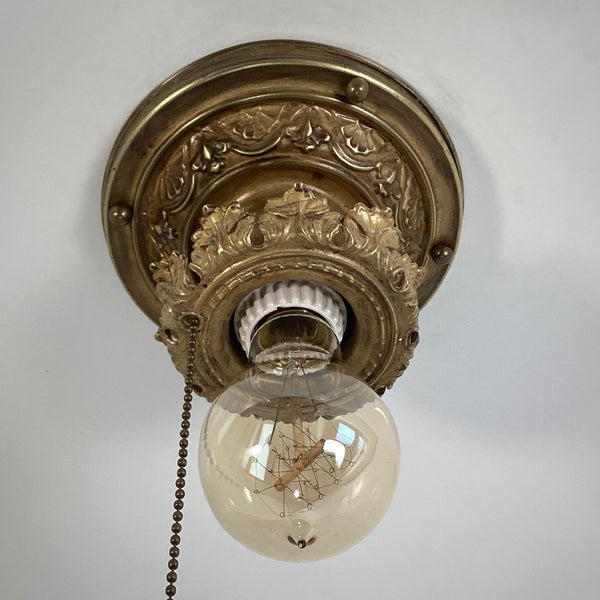 Antique Brass Flush Mount Ceiling Light with Pull Chain. The fixture has been rewired, cleaned, and detailed and retains much of its aging and wear. It also includes the hardware for easy installation. Available at www.vintporium.com