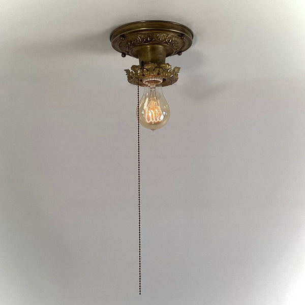 Antique Brass Flush Mount Ceiling Light with Pull Chain. The fixture has been rewired, cleaned, and detailed and retains much of its aging and wear. It also includes the hardware for easy installation. Available at www.vintporium.com