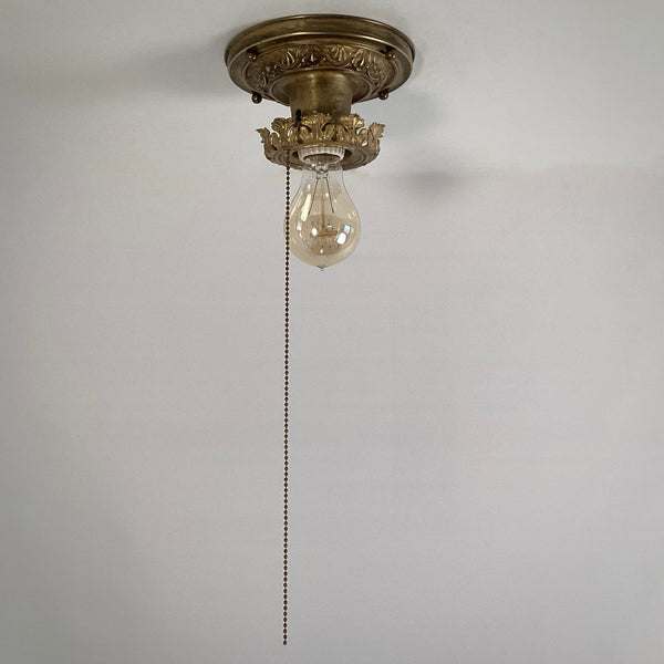 Antique Brass Flush Mount Ceiling Light with Pull Chain. The fixture has been rewired, cleaned, and detailed and retains much of its aging and wear. It also includes the hardware for easy installation. Available at www.vintporium.com