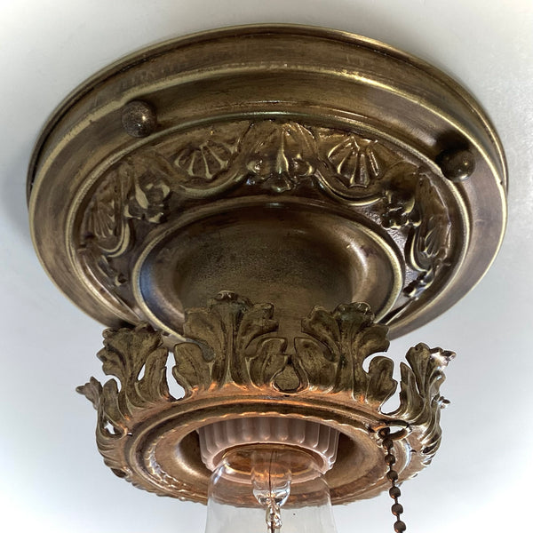 Antique Brass Flush Mount Ceiling Light with Pull Chain. The fixture has been rewired, cleaned, and detailed and retains much of its aging and wear. It also includes the hardware for easy installation. Available at www.vintporium.com
