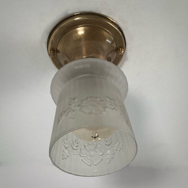 Vintage 1930s Empire Glass Ceiling Light – Floral Frosted Shade. 1930s with this charming flush mount ceiling light. Featuring a softly patinated brass canopy and a frosted glass shade adorned with embossed wildflowers and vertical fluting. Available at www.vintporium