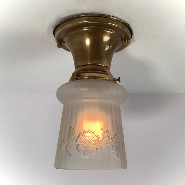 Vintage 1930s Empire Glass Ceiling Light – Floral Frosted Shade. 1930s with this charming flush mount ceiling light. Featuring a softly patinated brass canopy and a frosted glass shade adorned with embossed wildflowers and vertical fluting. Available at www.vintporium