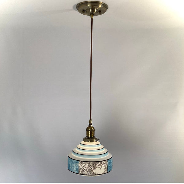 Stepped Art Deco pendant light fixture showing layered shade design and cloth-covered cord