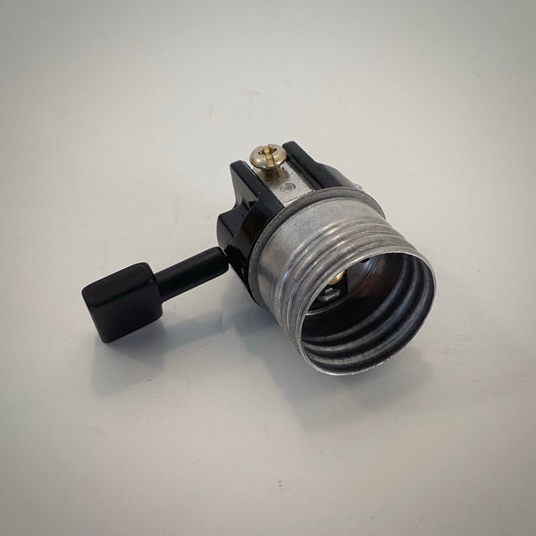 Angled view looking into the threaded metal shell of a Leviton 3-way medium base lamp socket interior.