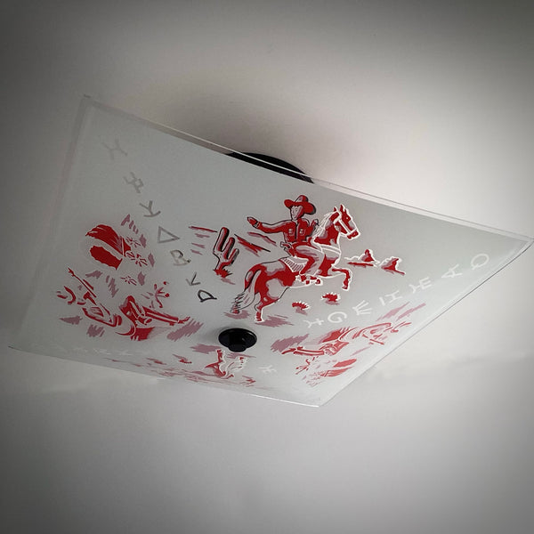 Perspective view of a retro square flush mount ceiling light featuring red western cowboy art and a dark central finial.
