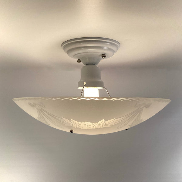Side profile of vintage 1950s semi flush ceiling light with frosted glass bowl and white enamel floral garland design