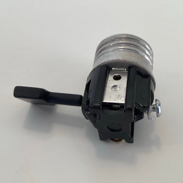 Back view of Leviton 3-way turn knob lamp socket interior showing black phenolic base and mounting slot.