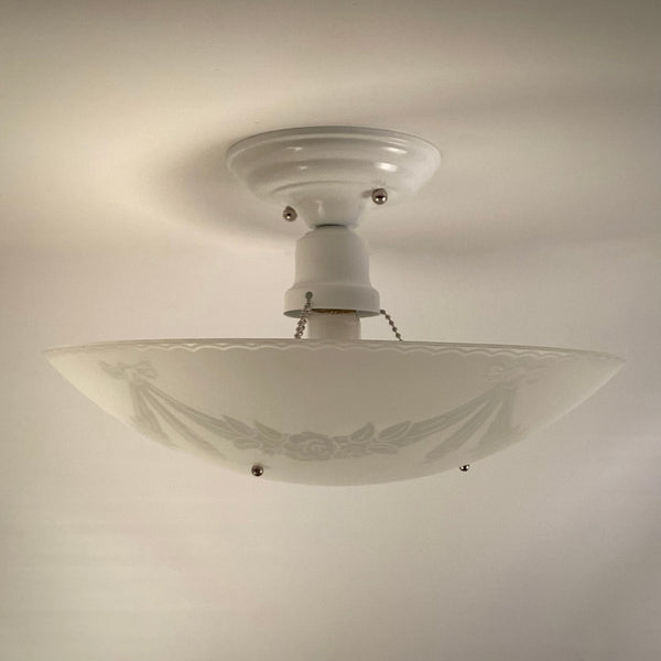 Detail of porcelain socket and powder coated canopy on restored 1950s semi flush ceiling light fixture