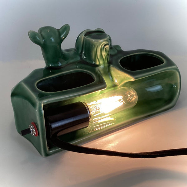 Back view of the TV lamp revealing the interior light bulb housing and black power cord.