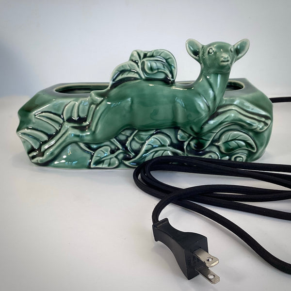 Close-up of the black cloth-covered power cable and vintage-style plug for an authentic MCM lamp.