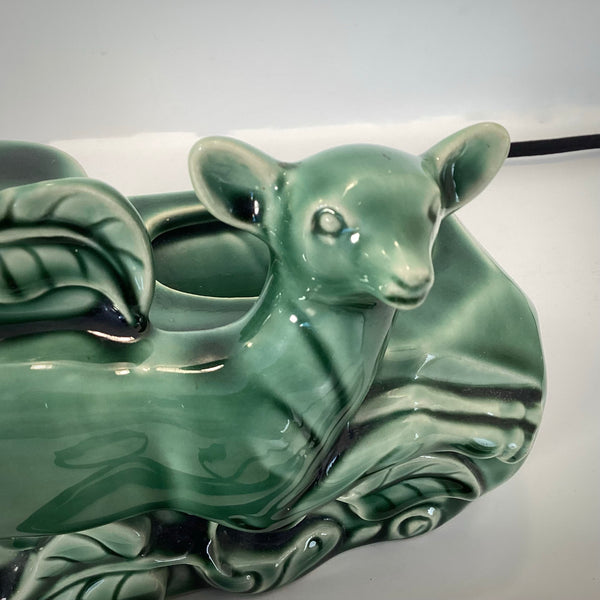 Macro detail shot of the ceramic doe's face and ears on a Mid-Century Modern decorative TV lamp.