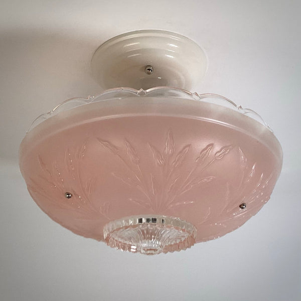 Unlit retro pink frosted glass ceiling shade highlighting the textured plant branch relief and scalloped upper edge.