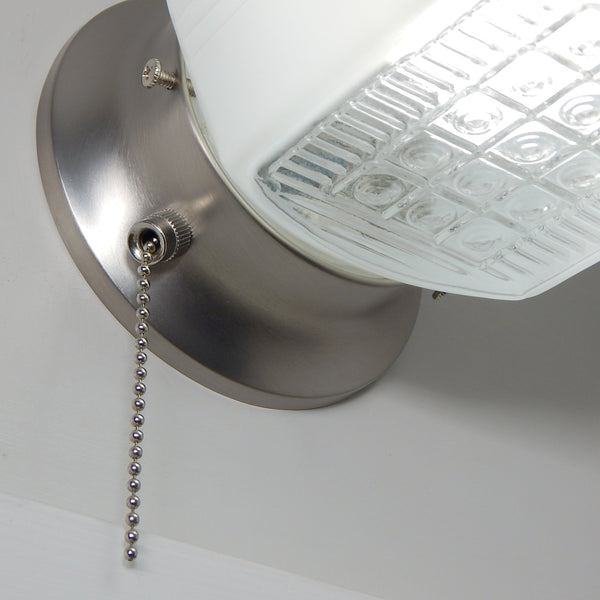 Angled view of mid-century Art Deco wall lamp featuring white enameled glass shade and nickel hardware.