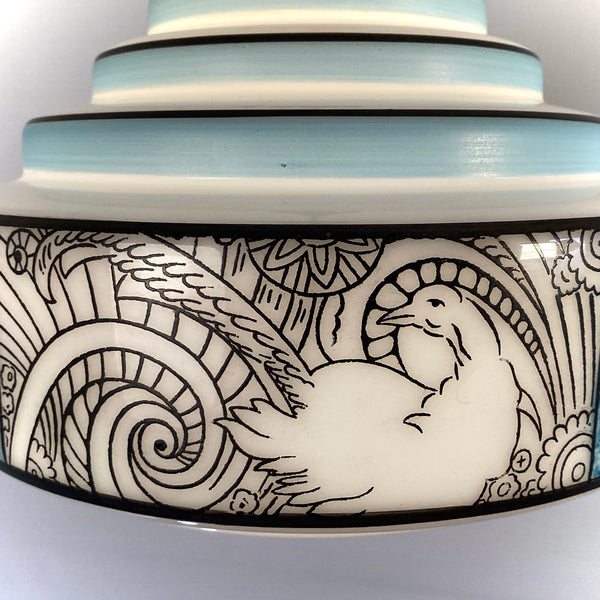 Close-up of black line pheasant motif and decorative scrollwork on vintage glass shade