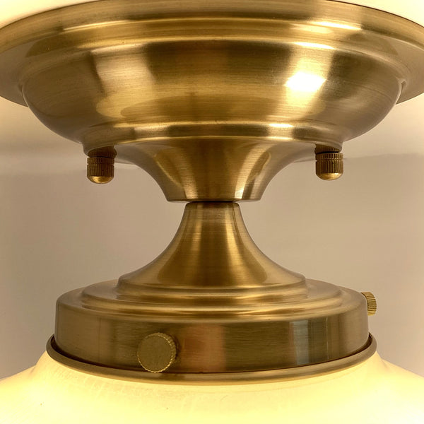 Extreme close-up of the brand new satin brass canopy, fitter, and mounting hardware for the Art Deco ceiling lamp.