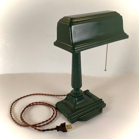 Antique Cast Iron Art Deco Bankers Lamp. This unique antique 1920s desk lamp, with its distinctive green enameled paint and brass highlights, is an outstanding piece. The fixture has been rewired, cleaned, and detailed for your convenience. Available at www.vintporium.com