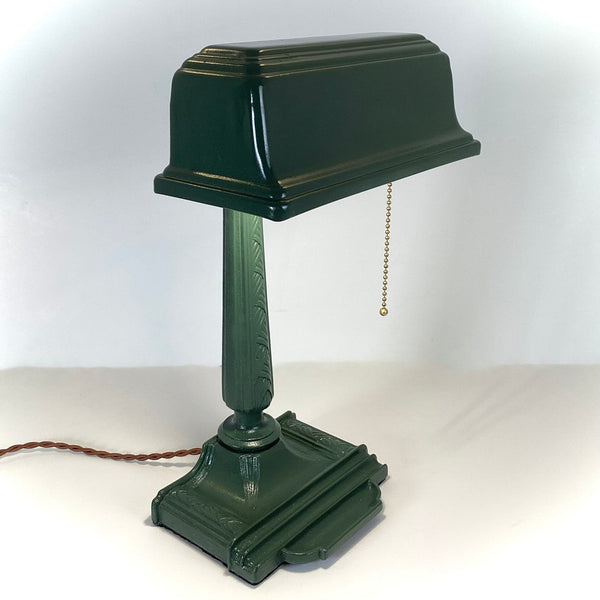 Antique Cast Iron Art Deco Bankers Lamp. This unique antique 1920s desk lamp, with its distinctive green enameled paint and brass highlights, is an outstanding piece. The fixture has been rewired, cleaned, and detailed for your convenience. Available at www.vintporium.com