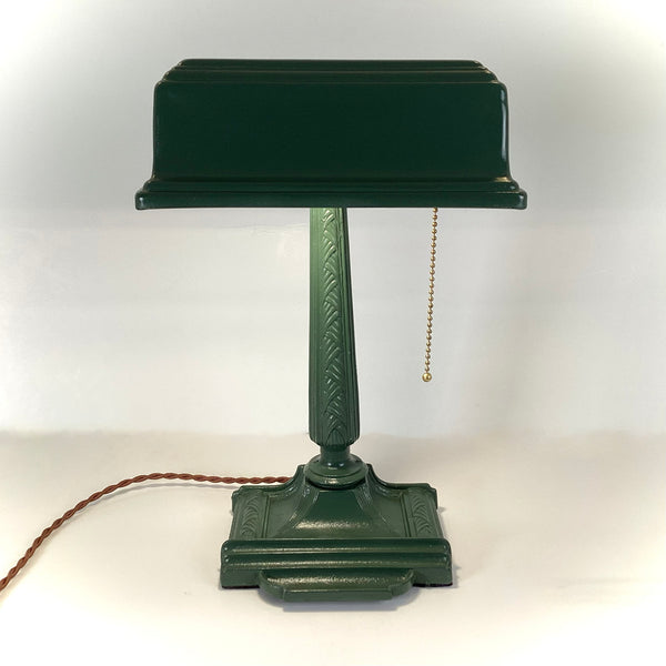 Antique Cast Iron Art Deco Bankers Lamp. This unique antique 1920s desk lamp, with its distinctive green enameled paint and brass highlights, is an outstanding piece. The fixture has been rewired, cleaned, and detailed for your convenience. Available at www.vintporium.com