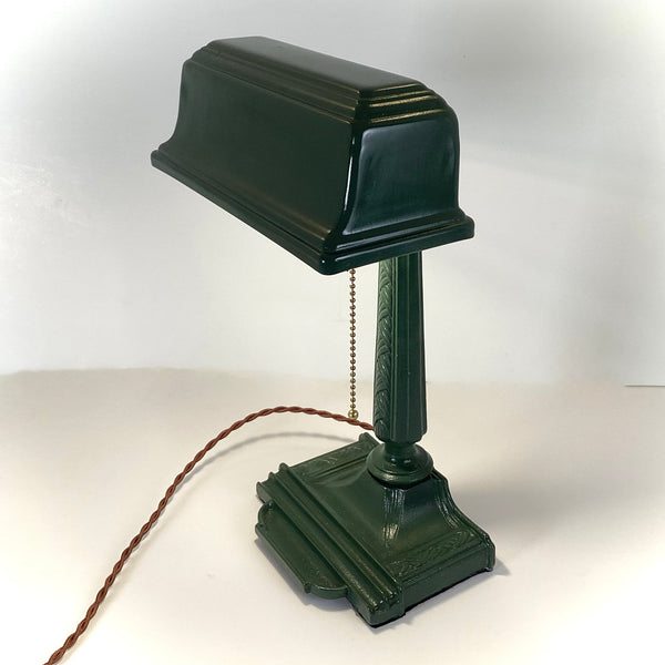 Antique Cast Iron Art Deco Bankers Lamp. This unique antique 1920s desk lamp, with its distinctive green enameled paint and brass highlights, is an outstanding piece. The fixture has been rewired, cleaned, and detailed for your convenience. Available at www.vintporium.com