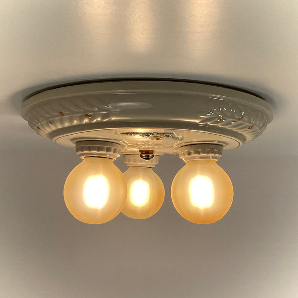 Antique Porcelain Flush Mount Pan Porcelain Ceiling Light Fixture. This beautiful antique porcelain ceiling light fixture features a classic 1930s design. The fixture has been restored and features new wiring, sockets, etc. It has been cleaned and detailed and is ready to install. Available at www.vintporium.com