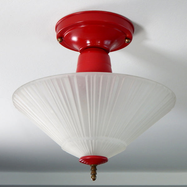 Antique Art Deco / Machine Aged Semi Flush Ceiling Light Fixture. The fixture has been restored and features a deep red with antique brass highlights. The fixture has been cleaned and detailed and comes with hardware for a convenient installation. Available at www.vintporium.com