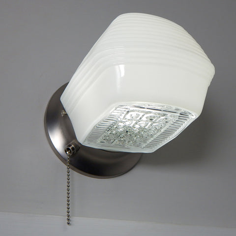 Post-War Era Pull Chain Equipped Sconce. Vintage Glass Shade. New Fixture Base. The fixture features a vintage enameled glass shade and a new pull chain fixture. The light comes with installation hardware, making it convenient to install. Available at www.vintporium.com