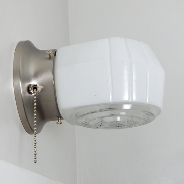 Post-War Era wall sconce, you get the perfect blend of form and function, giving you a classic American retro lighting solution and a practical one. They're easy to install and maintain, and their timeless design. The fixture features a vintage enameled glass shade and a new pull chain fixture. The light comes with installation hardware making it convenient to install. Available at www.vintporium.com