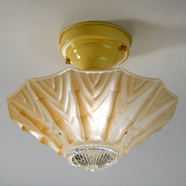 Interior designs of 1940s America were filled with a fascination with exotic tropical destinations and fueled with a sense of escapism, especially following World War II. The tropical-inspired ceiling light fixture features new wiring, porcelain sockets, etc. The fixture has been cleaned and detailed and comes with installation hardware, making for a convenient installation. Available at www.vintporium.com