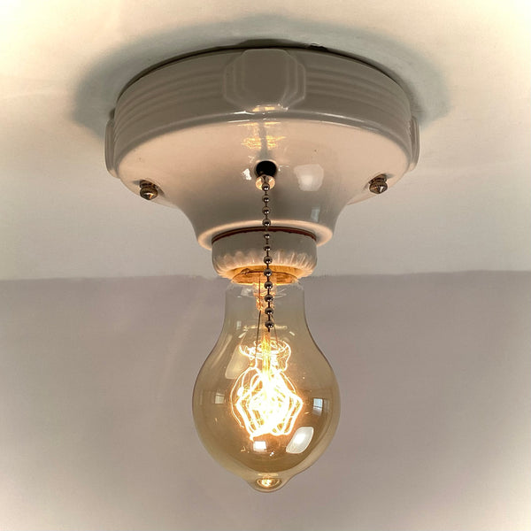 Vintage Deco Flush Mount Ceiling Light Fixture with Pull Chain. This vintage deco porcelain light fixture has been restored and features a new porcelain pull chain socket, wiring, etc. The fixture has been cleaned and detailed, making for a convenient installation.