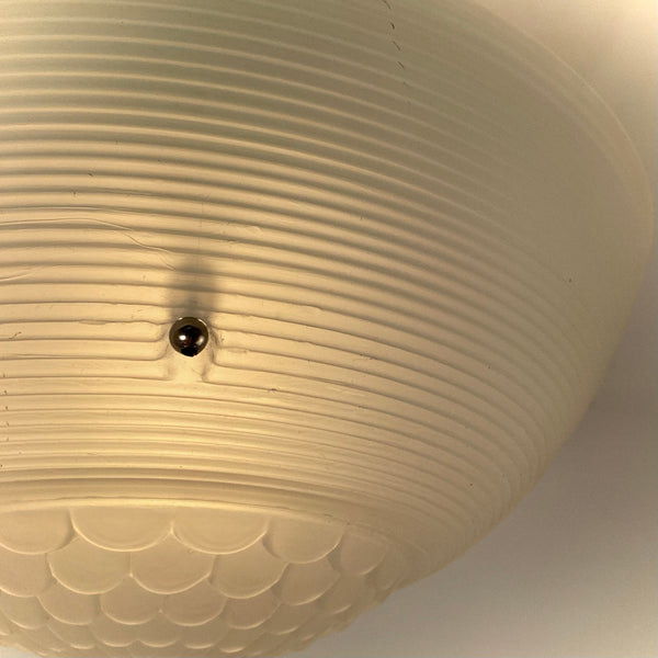 Jadeite-green vintage ceiling light with warm glowing ribbed glass shade.