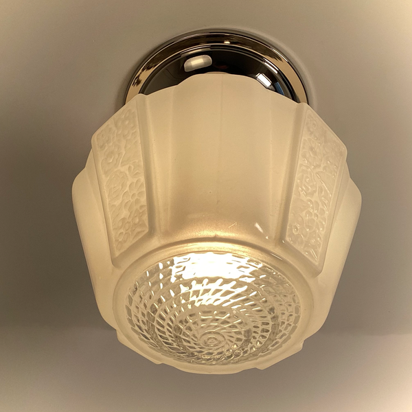 Underside view of vintage frosted glass ceiling light lit with warm glow – Vintporium