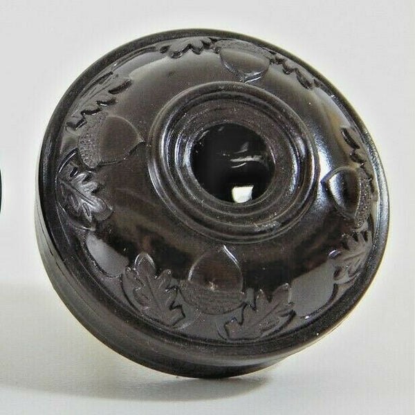 Early electric replica embossed acorn and oak leaf motif bakelite plug. The plug features an insulator and polarized prongs.  Available at www.vintporium.com