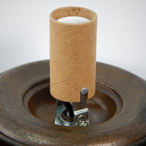 Porcelain lighting socket with brown paper sleeve mounted in an antique metal lamp base, Vintporium.