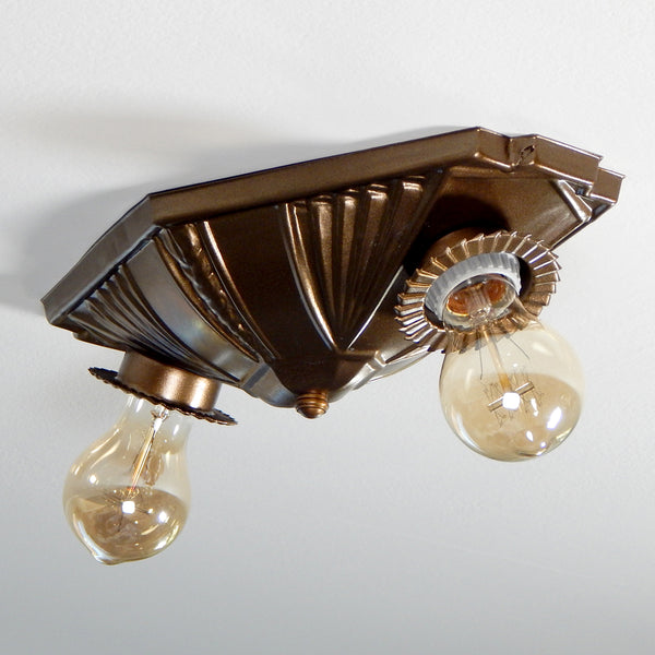 The geometric stamped pattern and buzz saw-inspired bobeches of this flush mount ceiling light is a unique surviving relic of Machine Age décor that would have been produced and marketed to American consumers in the Mid-20th Century. The light fixture has been restored, rewired, and is ready to install for your convenience. Available at www.vintporium.com