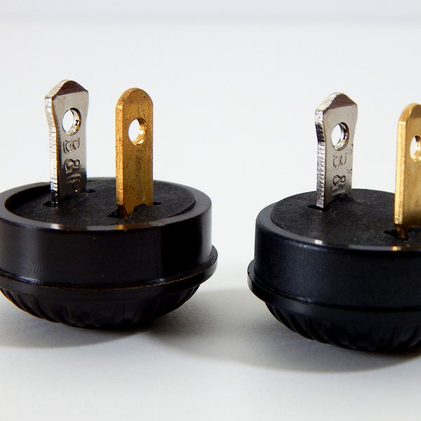 Early electric replica embossed ribbed motif bakelite plug. The plug features an insulator and polarized prongs.  Available at www.vintporium.com