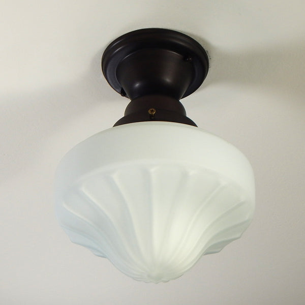 The semi-flush schoolhouse fixture features a salvaged satin opal glass shade and a new UL Listed provincial bronze fixture base. The piece has been cleaned, detailed, and is ready to install. Available at www.vintporium.com
